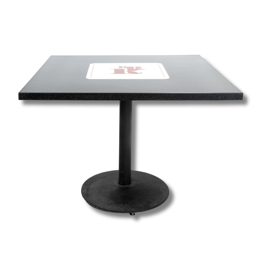 A square table with a dark granite-like top and embedded QR code in the center, supported by a single black central pedestal and circular base against a dark background.